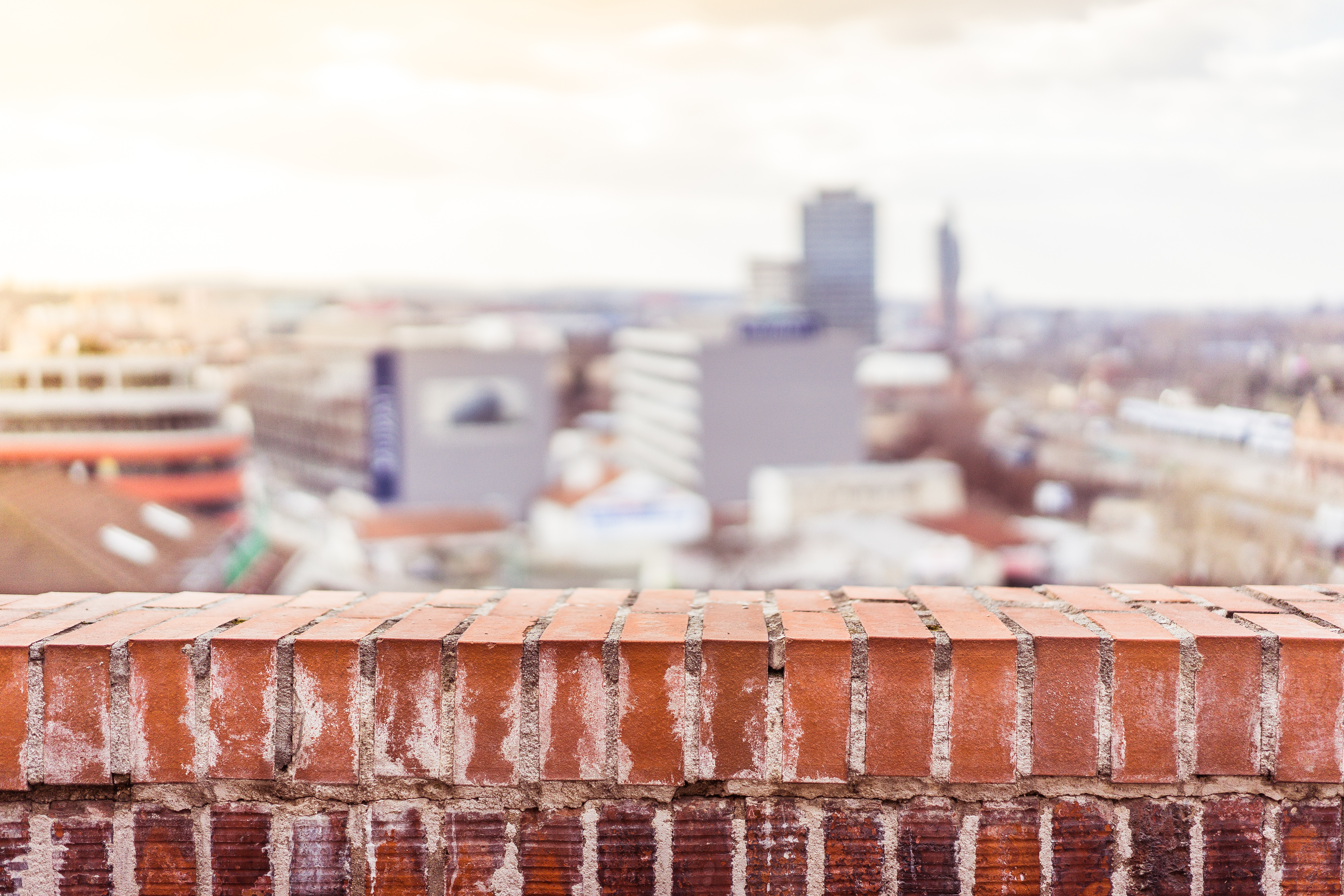 empty-brick-wall-with-blurred-city-view-background-picjumbo-com